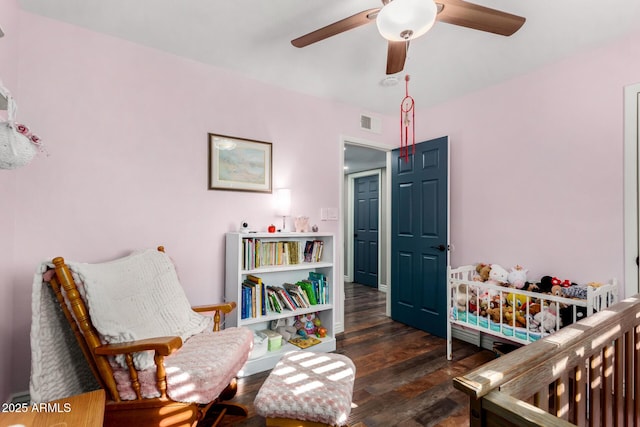 bedroom with dark hardwood / wood-style floors and ceiling fan