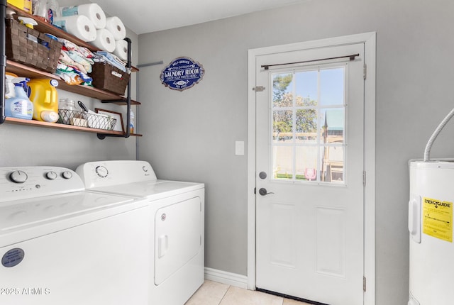 clothes washing area featuring water heater, light tile patterned floors, and independent washer and dryer