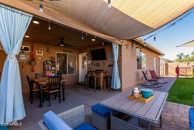 view of patio with ceiling fan and exterior bar