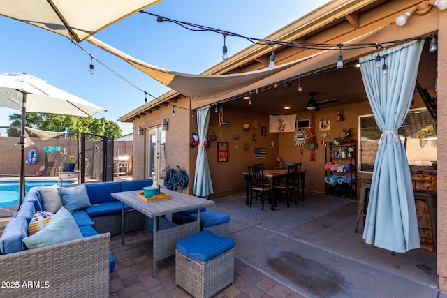 view of patio / terrace with a fenced in pool, outdoor lounge area, and ceiling fan