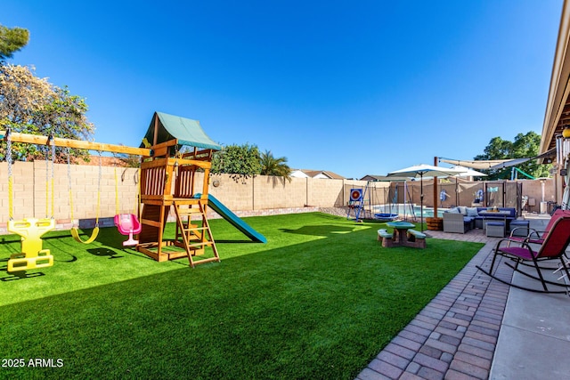 view of yard featuring an outdoor living space, a patio area, and a playground