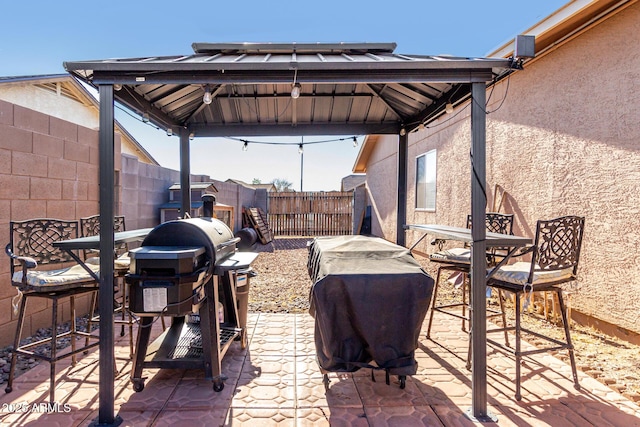 view of patio with a grill and a gazebo