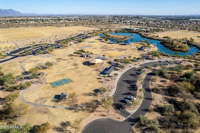 birds eye view of property with a water and mountain view