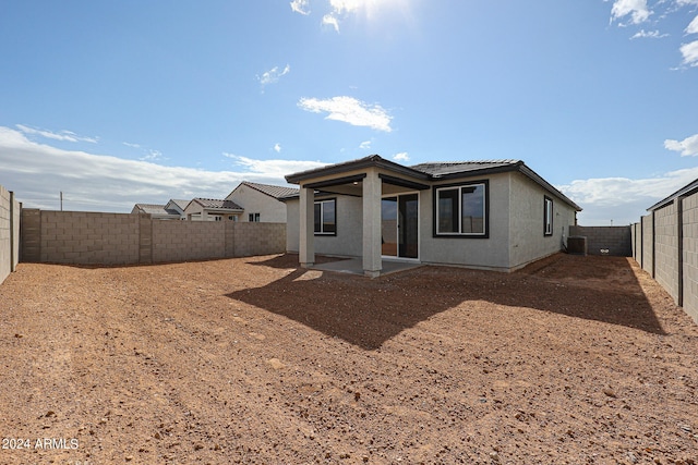 back of property featuring a patio and cooling unit