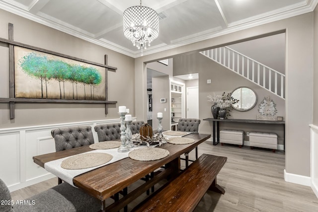1179 E Regent Dr, Gilbert, AZ 85298 - dining area with a chandelier, ornamental molding, light wood-type flooring, coffered ceiling, and wainscoting