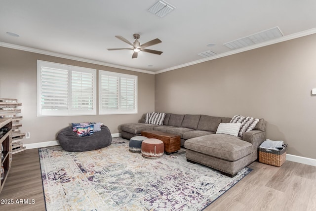 1179 E Regent Dr, Gilbert, AZ 85298 - living area with a ceiling fan, crown molding, wood finished floors, baseboards, and plenty of natural light