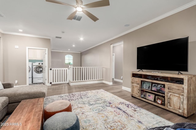 1179 E Regent Dr, Gilbert, AZ 85298 - living area featuring washer and clothes dryer, ceiling fan, ornamental molding, wood finished floors, and recessed lighting
