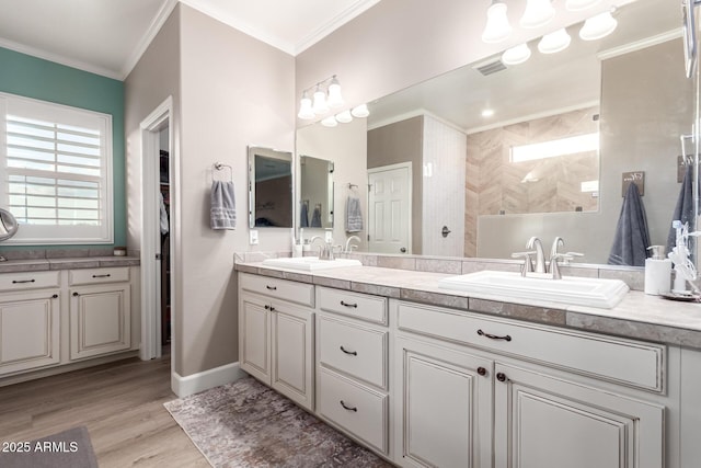1179 E Regent Dr, Gilbert, AZ 85298 - bathroom featuring healthy amount of natural light, wood finished floors, walk in shower, double vanity, and ornamental molding