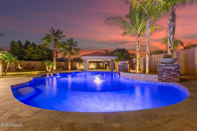 1179 E Regent Dr, Gilbert, AZ 85298 - pool at dusk with a gazebo, a fenced backyard, and a patio area