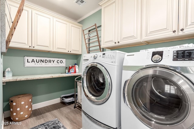 1179 E Regent Dr, Gilbert, AZ 85298 - clothes washing area featuring independent washer and dryer, cabinet space, light wood finished floors, ornamental molding, and baseboards