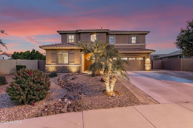 1179 E Regent Dr, Gilbert, AZ 85298 - mediterranean / spanish home featuring driveway, stone siding, and fence