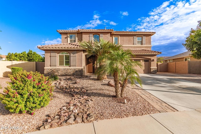 1179 E Regent Dr, Gilbert, AZ 85298 - mediterranean / spanish house featuring driveway, fence, stucco siding, stone siding, and a garage