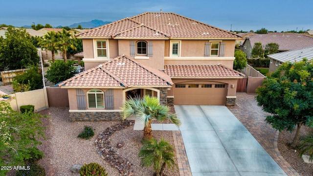 1179 E Regent Dr, Gilbert, AZ 85298 - mediterranean / spanish house with stucco siding, fence, concrete driveway, and a tile roof