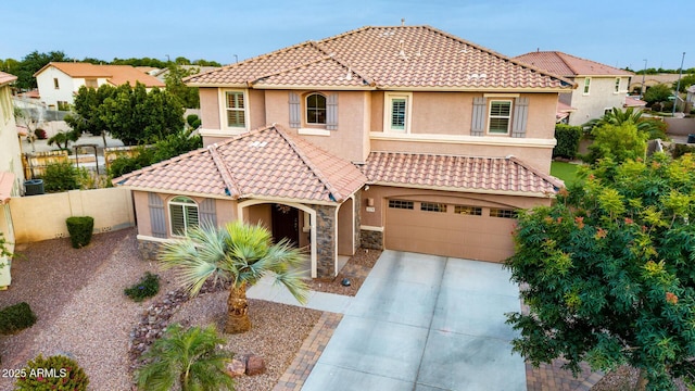 1179 E Regent Dr, Gilbert, AZ 85298 - mediterranean / spanish home with stucco siding, a tiled roof, driveway, an attached garage, and fence
