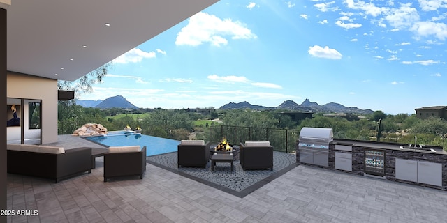 view of patio / terrace with exterior kitchen, area for grilling, and a mountain view