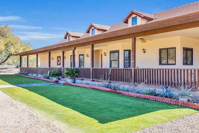 view of front of house featuring covered porch and a front yard