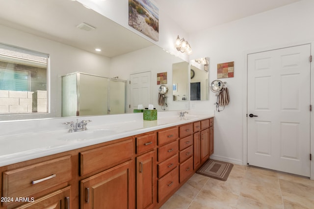 bathroom featuring vanity, tile patterned flooring, and walk in shower