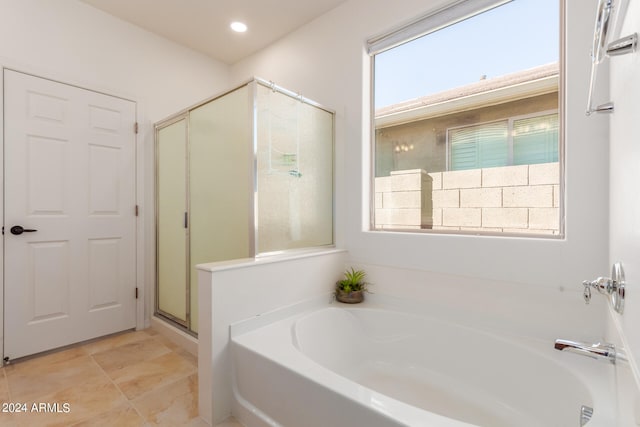 bathroom featuring independent shower and bath