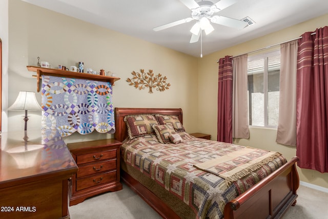 bedroom featuring light colored carpet and ceiling fan