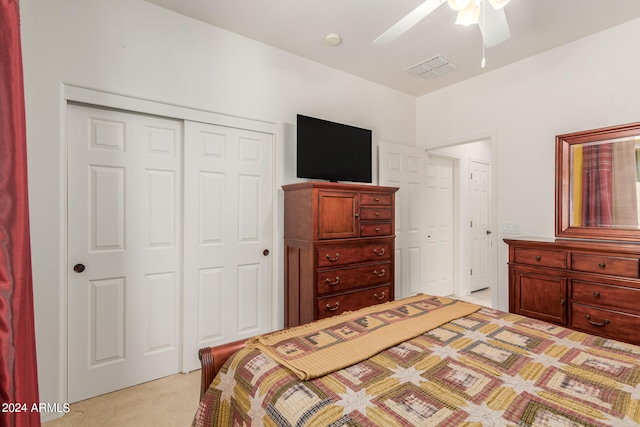 carpeted bedroom featuring a closet and ceiling fan