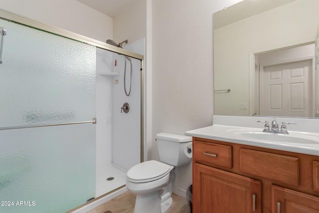 bathroom featuring a shower with door, toilet, tile patterned floors, and vanity