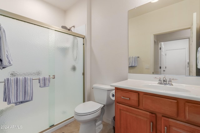 bathroom with vanity, toilet, and an enclosed shower