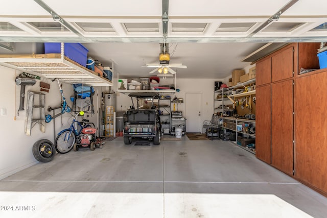 garage with a workshop area and gas water heater