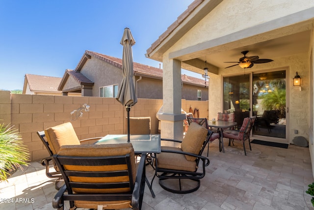 view of patio featuring ceiling fan