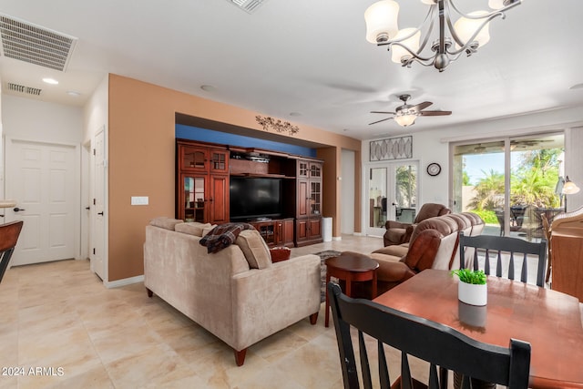 living room featuring french doors and ceiling fan with notable chandelier