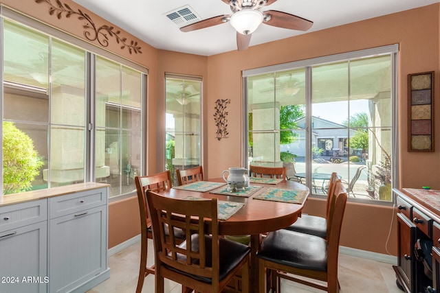 dining space featuring ceiling fan, light tile patterned flooring, and a wealth of natural light