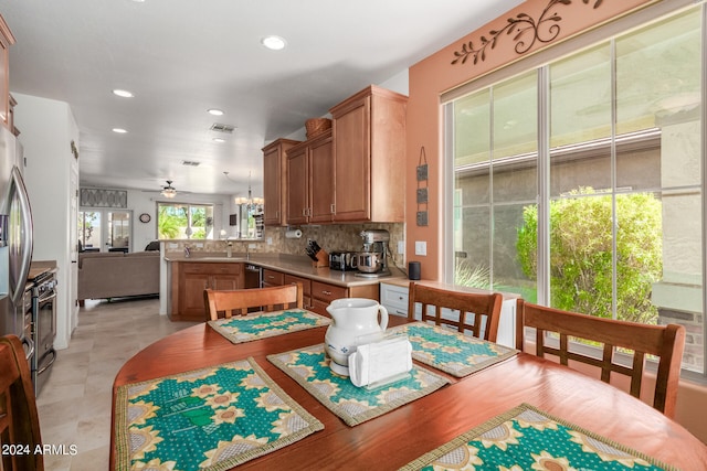 tiled dining room with sink and ceiling fan