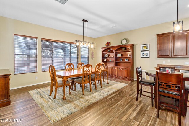 dining room featuring dark hardwood / wood-style flooring and an inviting chandelier