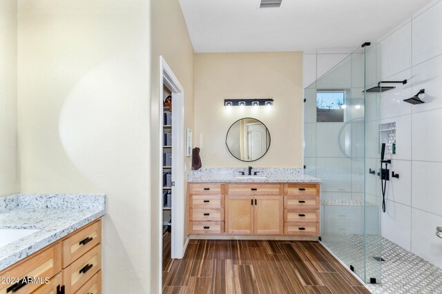 bathroom with vanity and an enclosed shower