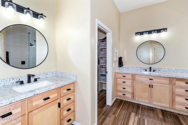 bathroom featuring vanity and a shower with door