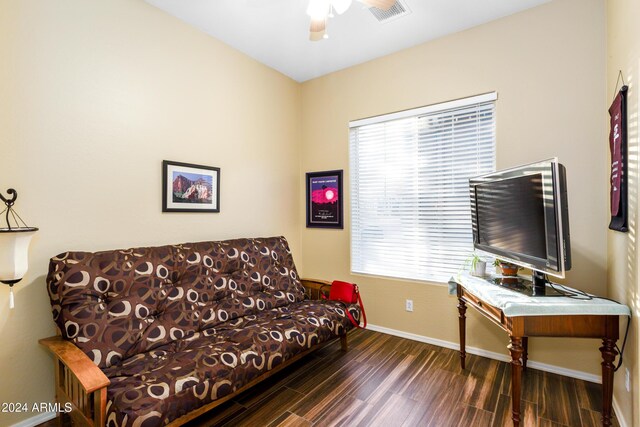 living room with ceiling fan and dark hardwood / wood-style flooring