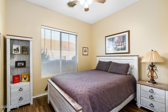 bedroom with dark hardwood / wood-style floors and ceiling fan