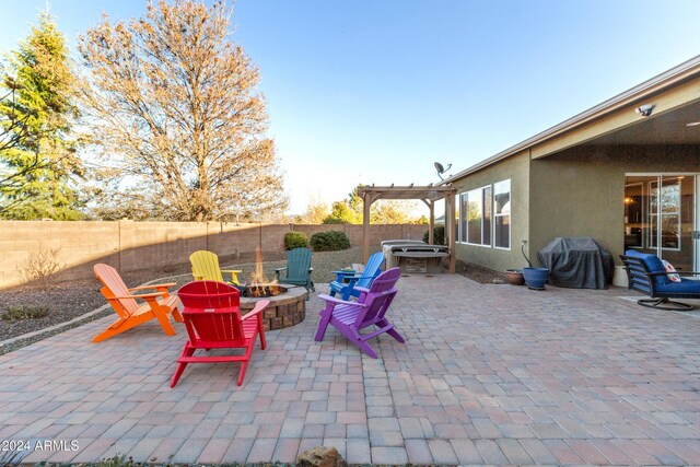 view of patio featuring a pergola, a grill, and a fire pit