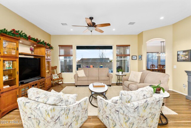 living room featuring ceiling fan and light wood-type flooring