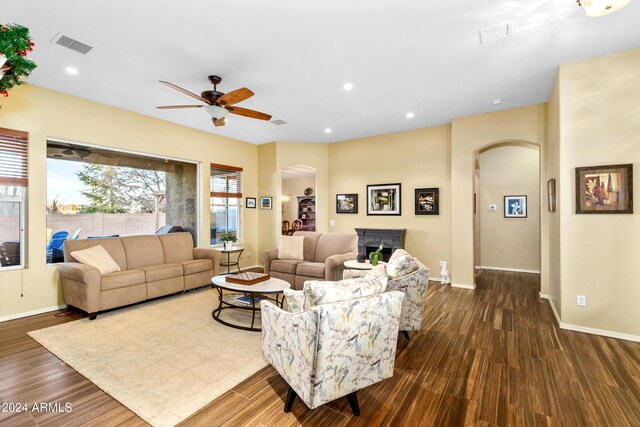 living room featuring dark hardwood / wood-style flooring and ceiling fan