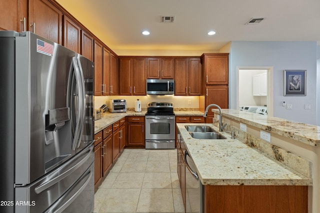 kitchen with an island with sink, visible vents, stainless steel appliances, and a sink