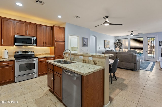 kitchen with light tile patterned floors, visible vents, stainless steel appliances, and a sink