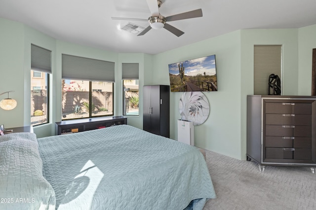 bedroom with carpet, visible vents, and a ceiling fan