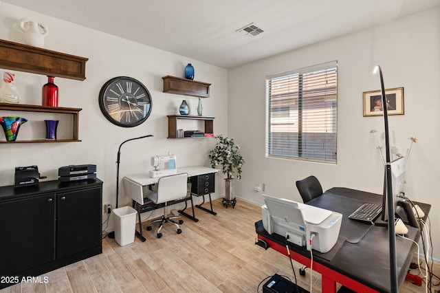 home office with baseboards, visible vents, and light wood-style floors