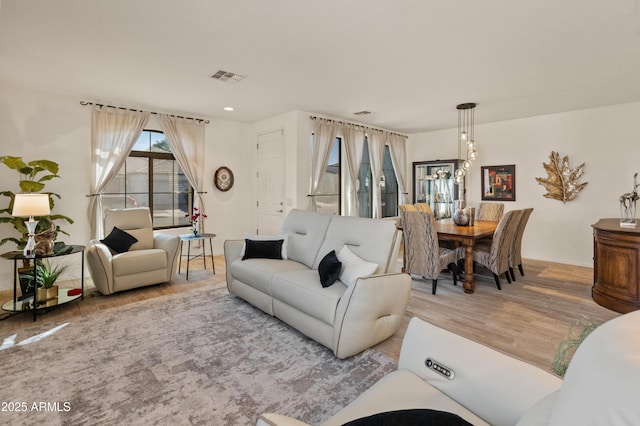 living area featuring visible vents, wood finished floors, and recessed lighting