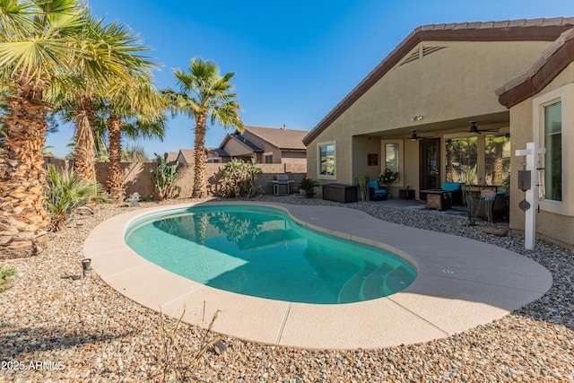 view of swimming pool with a patio area, a fenced backyard, a ceiling fan, and a fenced in pool