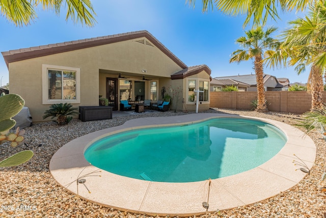 view of pool featuring ceiling fan, a patio, outdoor lounge area, fence, and a fenced in pool