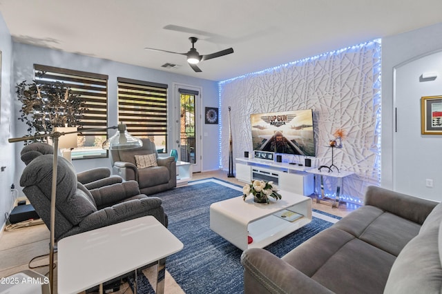 living area featuring ceiling fan and visible vents