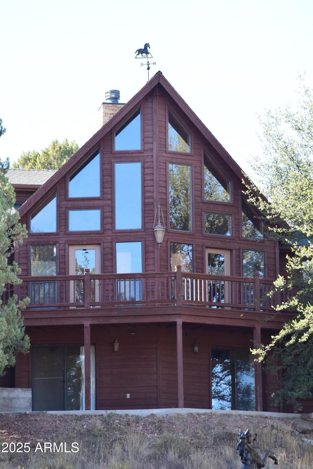 back of house with a chimney