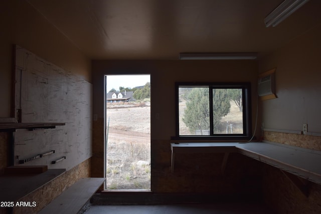 doorway to outside featuring a wall unit AC