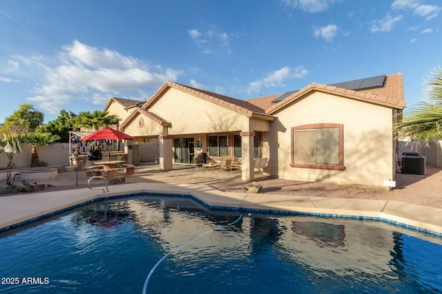 back of house featuring a gazebo, solar panels, a patio area, and central AC